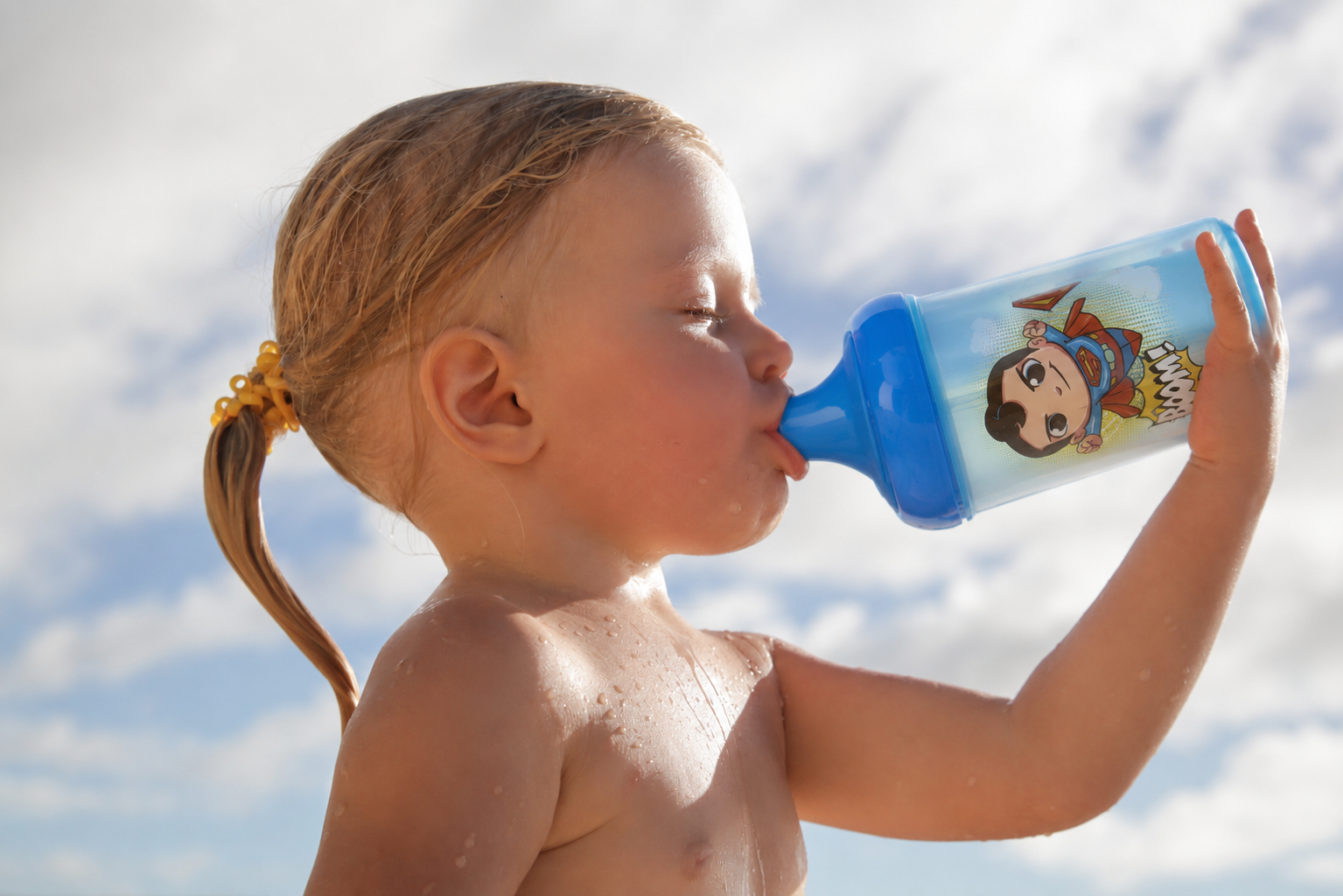 Toddler at the beach with DC Baby swimwear