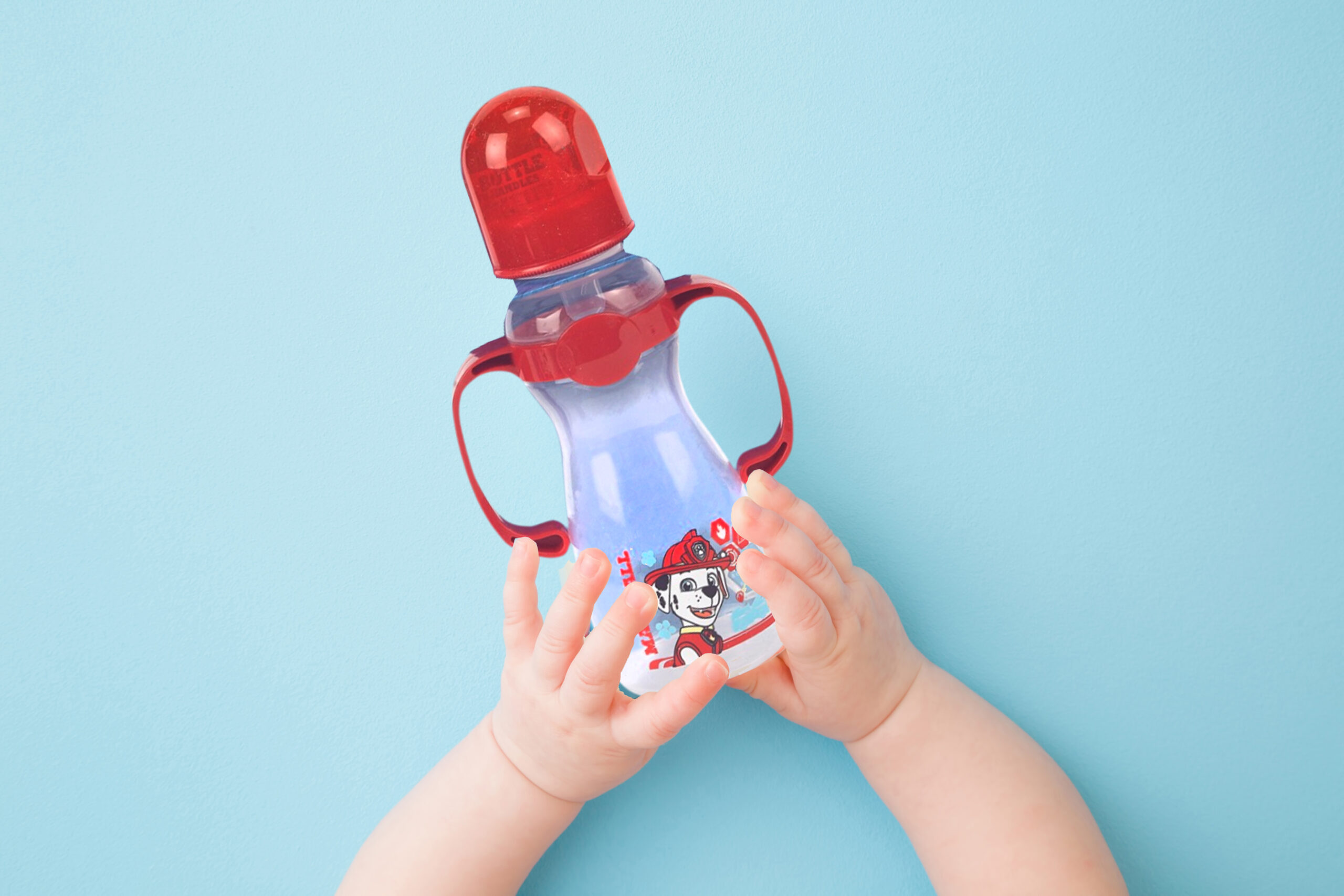 Baby holding a Paw Patrol bottle